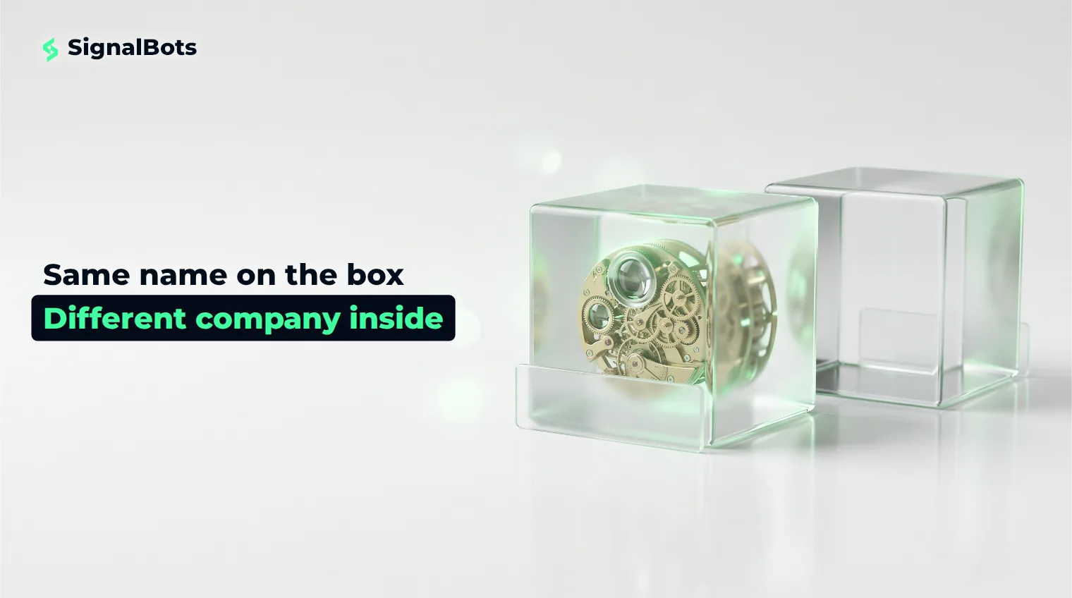 Two identical glass cubes with matching blank nameplates; the near one holds an intricate mechanism, the far one is hollow.