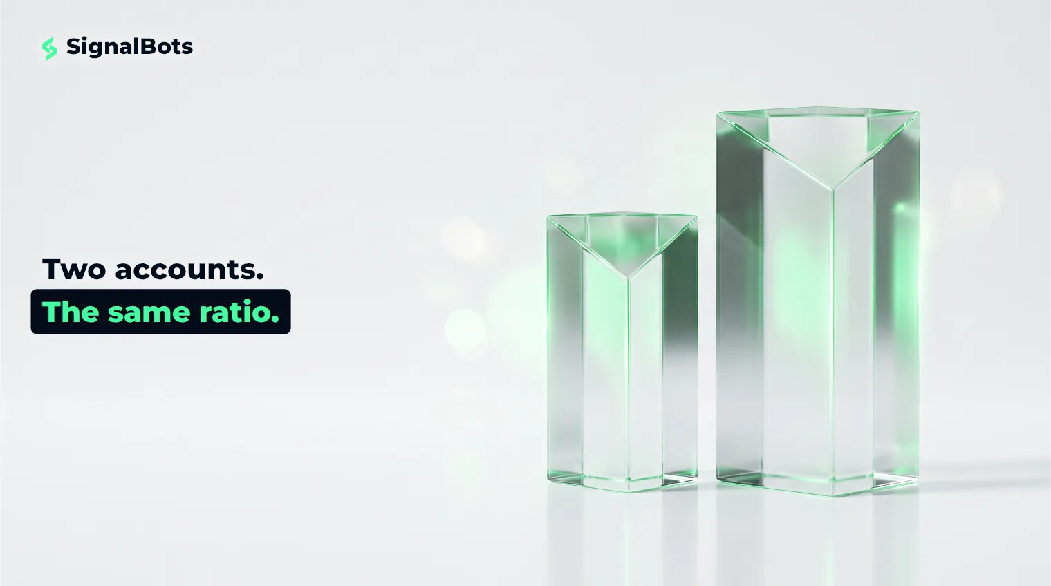 Two identical glass prisms at different sizes standing side by side, one an exact scaled copy of the other.